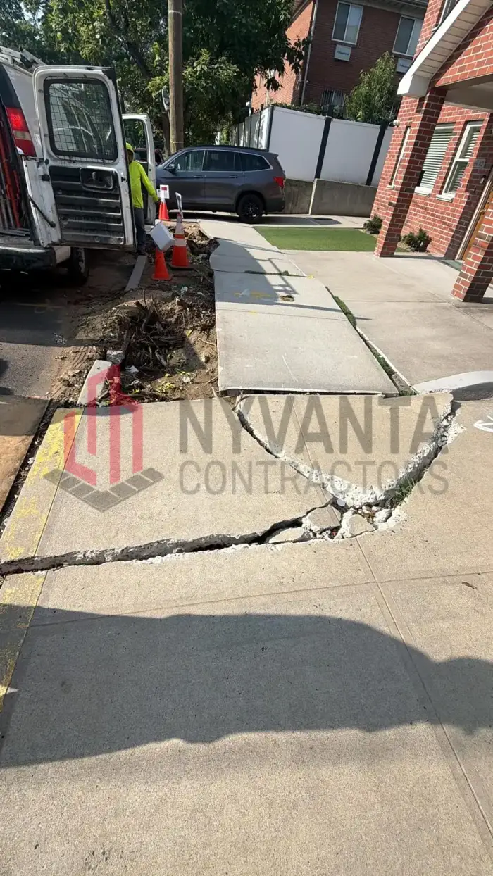 Cracked and broken sidewalk flag at 61-42 168th St in Flushing, Queens