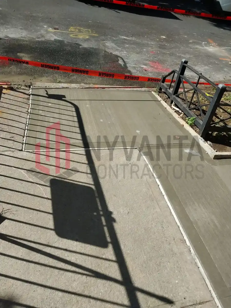 Newly poured sidewalk flags beside the tree pit at 326 Atlantic Ave, work zone taped off