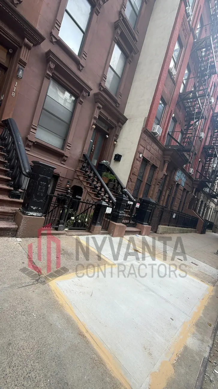 Completed tree-root sidewalk repair outside the brownstone at 120 W 127th St in Harlem